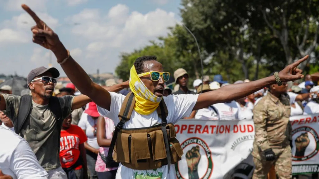 Operation Dudula members in action during one of their campaigns against foreign nationals. (Pic: BBC)