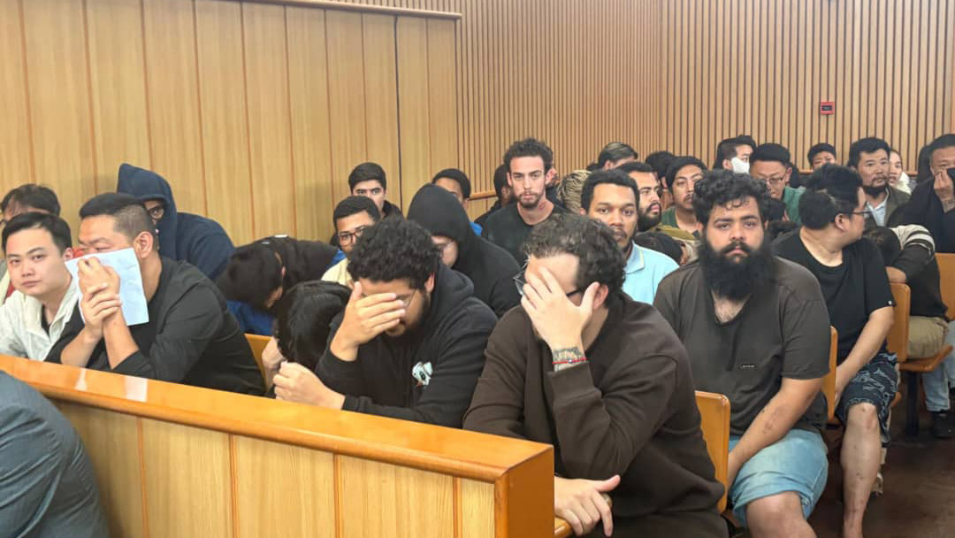 Some of the foreign nationals hiding their faces from the camera avoiding to be taken pictires. (Pics:Mnelisi Dlamini)