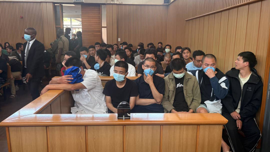 The arrested foreigners following proceedings of the court.