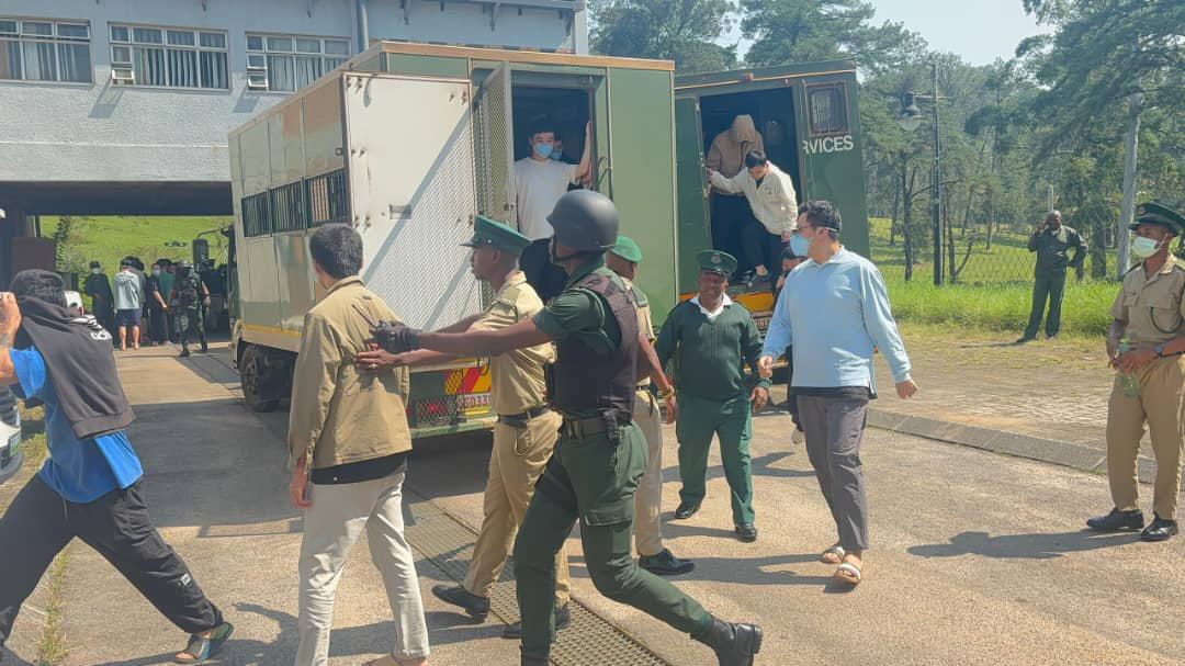 The foreign nationals being escorted by His Majesty’s Correctional Services Officers to the court upon their arrival.